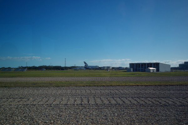 Crawler transporter tracks with a space shuttle in the background